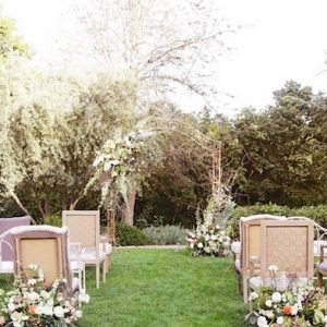 Mismatched Vintage Ceremony Seating with Floral Arch