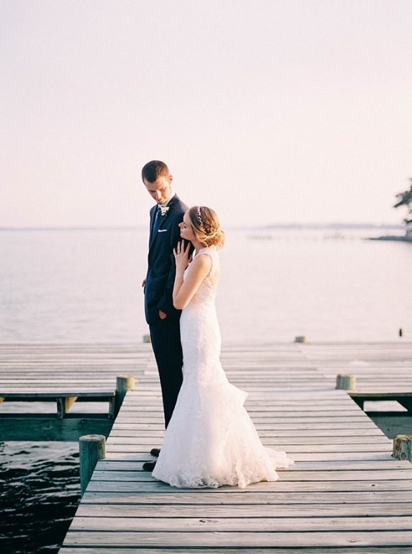 Bride and groom on a dock on the bay