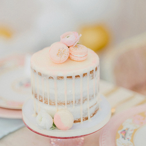 Pink drip cake with macaron topper