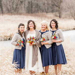 Bridesmaids in wraps with felt flower bouquets