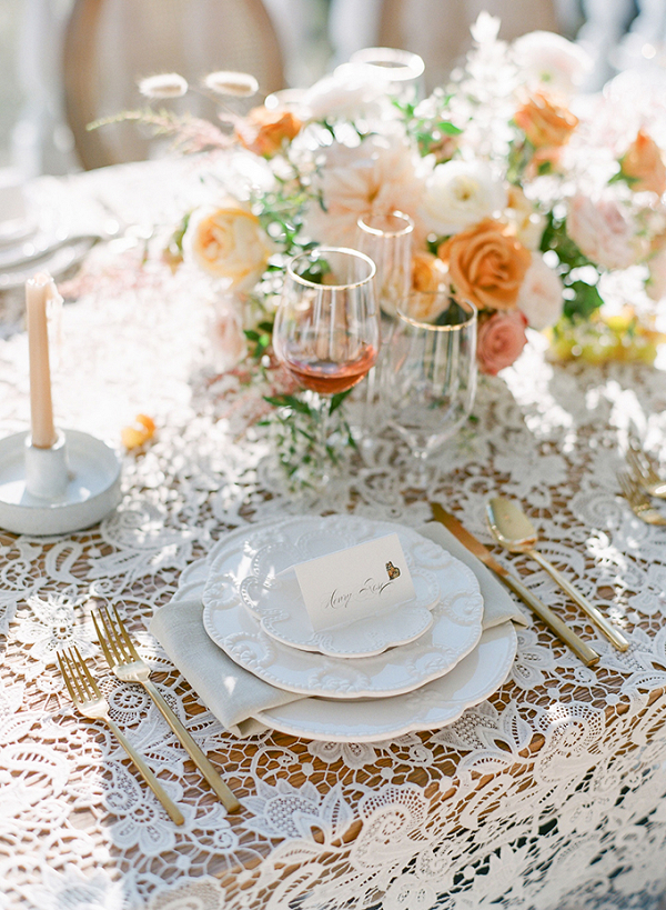 Romantic peach wedding table with lace linens