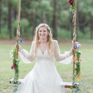 Bride on floral covered swing