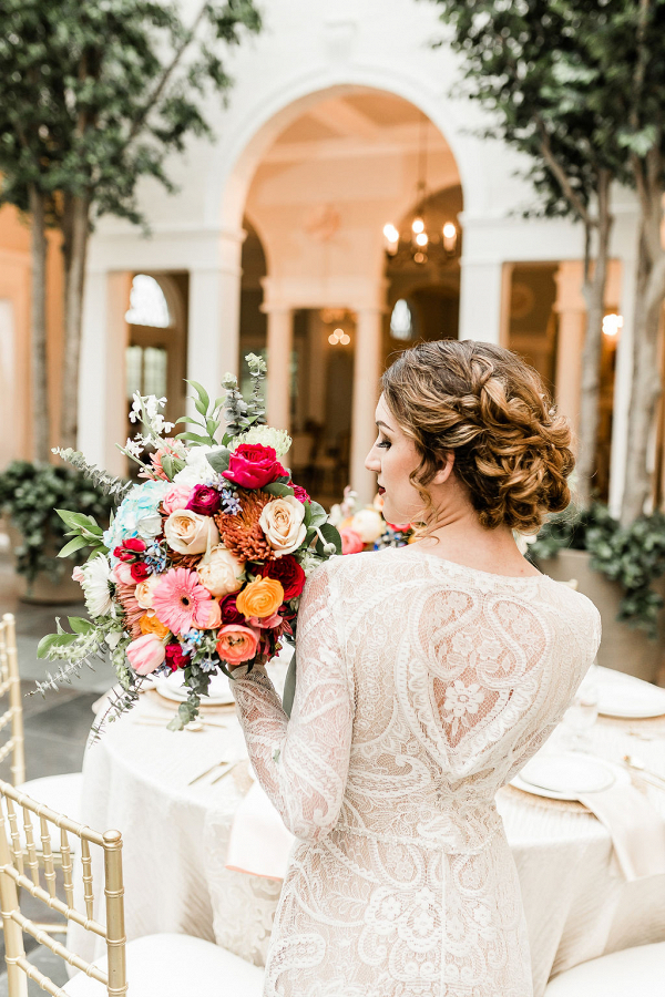 bride holding a colorful baroque bouquet