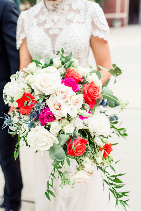bride holding a pink orange and white bouquet