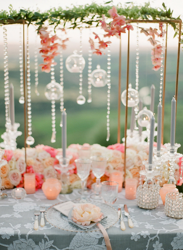 coral tablescape featuring glass orbs and hanging crystals