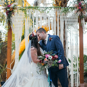 Bohemian Macrame Wedding Ceremony Backdrop with Colorful Fall Flowers
