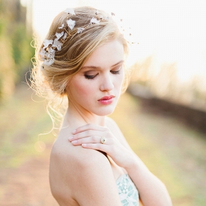 Graceful Bridal Updo with a Delicate Halo Headpiece