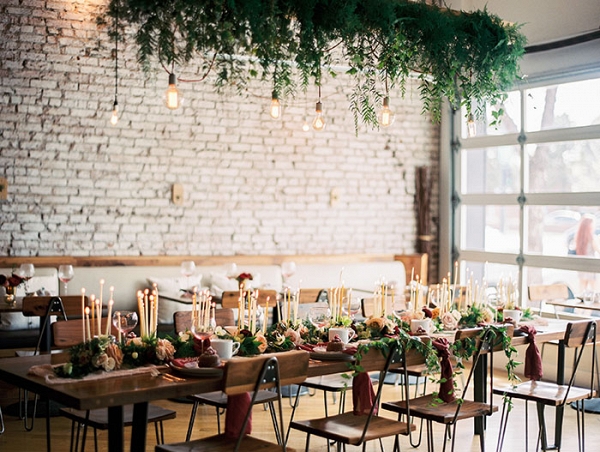 Cozy Winter Wedding Reception with Exposed Brick and Hanging Greenery