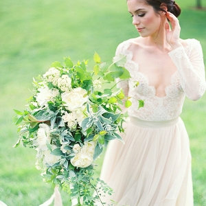 Long Sleeve Lace Wedding Dress with a Greenery Bouquet