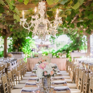 Sparkling Reception Tables under a Crystal Chandelier