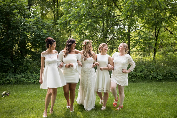Bridesmaids in mismatched short white dresses