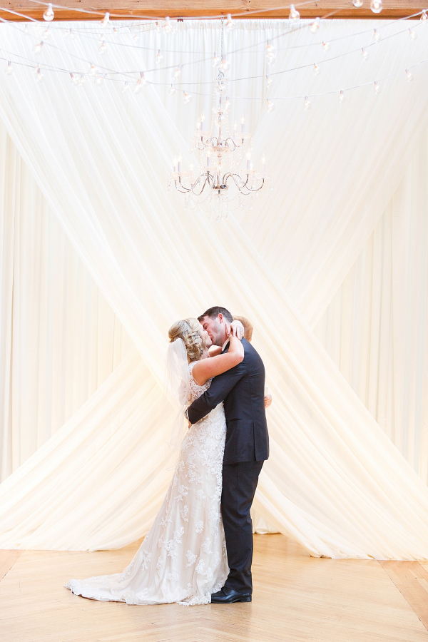 Wedding couple with dramatic draping backdrop