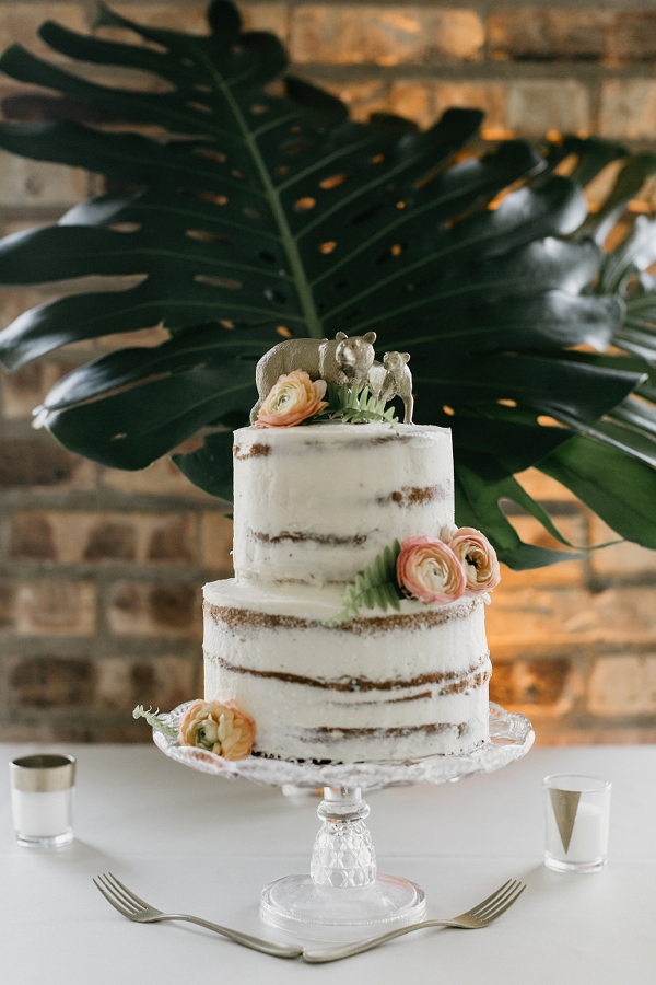 Semi naked wedding cake with animal cake topper