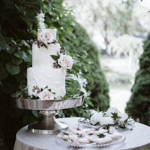 Romantic buttercream wedding cake with fresh florals