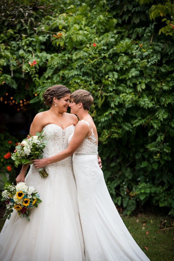 Two brides with sunflower bouquets