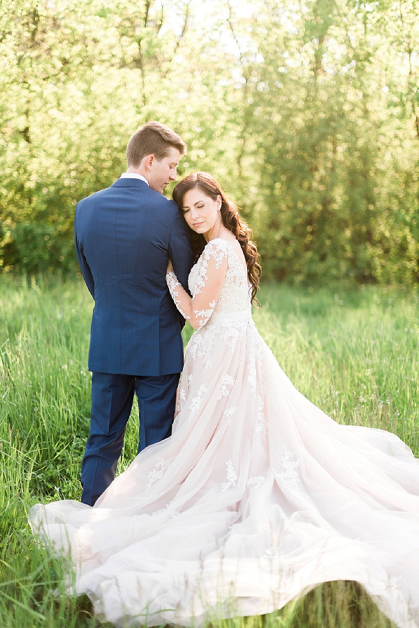 Wedding portrait with bride in long sleeve blush lace gown