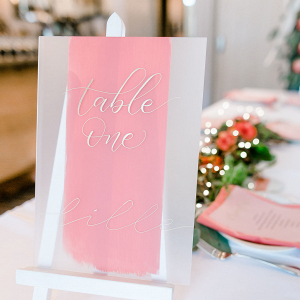 Coral table name on acrylic with gold calligraphy