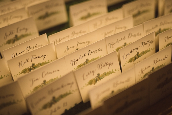 Calligraphy escort cards with botanical prints