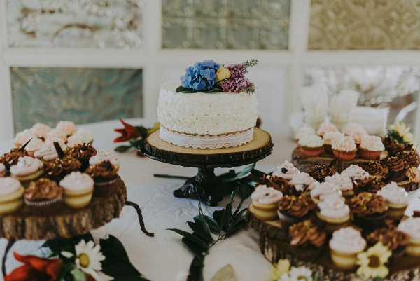 Small wedding cake with cupcakes