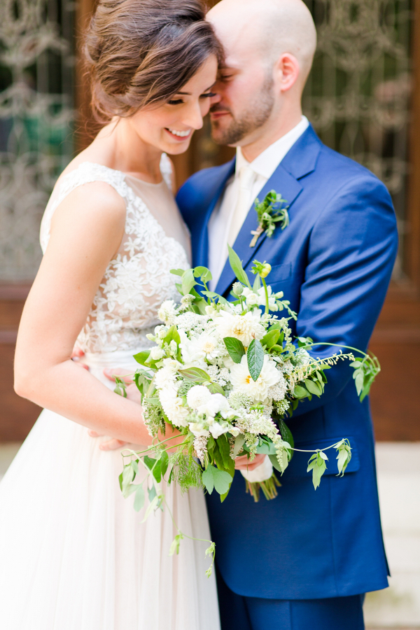 Bride and groom with lush bouquet