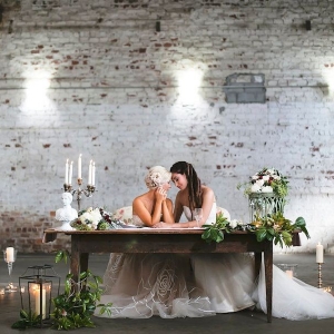 Same Sex Gay Couple at Vintage Wooden Sweetheart Table at Wedding Reception, Surrounded by Candlelight and Flowers Bohemian/Boho Styled Wedding Shoot