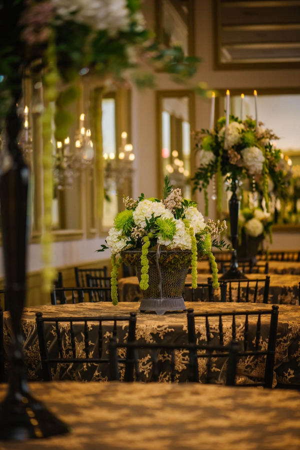 Cascading White and Green Hydrangea and Spider Flower Wedding Centerpiece in Dark Bronze Vase on Embroidered Gold Tablecloths 