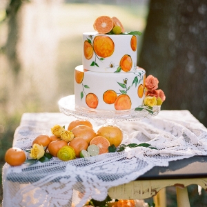 Hand-Painted Wedding Cake with Orange Citrus Cake Topper on Vintage and Lace Table