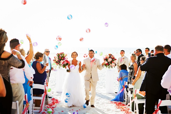 Beach, Outdoor Wedding Ceremony, Bride and Groom Walking down Aisle and Guests Throwing Beachballs