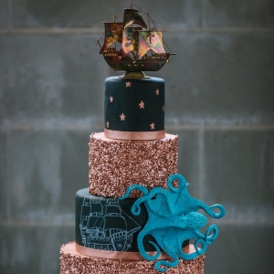 Black and Gold 5 Tiered Nautical Inspired Wedding Cake with Pirate Ship and Octopus Details