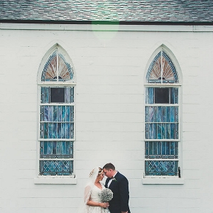 Bride and Groom Wedding Portrait in front of White Church with Stained Glass | Ybor City Wedding Church Venue Amazing Love Ministries