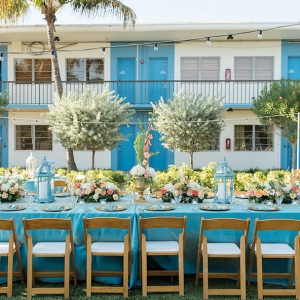 Outdoor, St. Petersburg Wedding Reception Table Decor with Wooden Chairs, Blue Table Linens, and Peach and Ivory Floral Wedding Centerpieces and Blue Lanterns 