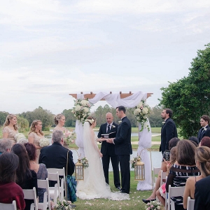 Bride and Groom Outdoor Wedding Ceremony with Arch and Draping