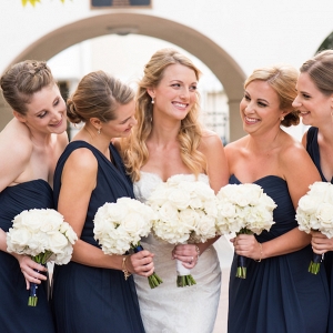 Bridal Party Portrait with Bride an Bridesmaids in Navy Bridesmaids Dresses and White Floral Wedding Bouquets