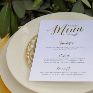 Wedding Reception Place Setting with Custom White Menu Card with Script Gold Accents and Gold Charger Plate