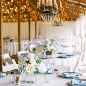 Wedding Reception Tablescape with Champagne Gold Charger Plates and Light Blue Linen Napkins with Low White and Light Blue Hydrangea Centerpieces