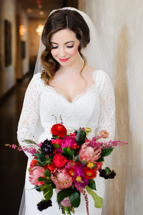 Bright Pink and Red Wedding Bouquet and Bride in Mikaella Bridal Lace Wedding Dress with Sleeves