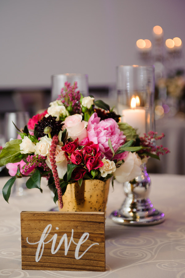 Modern and Rustic Wedding Reception with Pink, White and Red Centerpieces in Gold Vase and Wooden Table Number