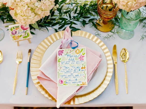 Wedding Reception Place Setting with Gold Charger and Gold Silverware with Watercolor Menu Card with PersonalIzed Cookie Favor with Name Card and Hydrangea Floral Decor 