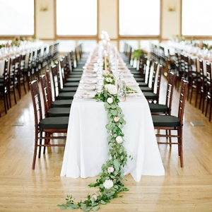 Long wedding tables with floral and greenery centerpiece runners