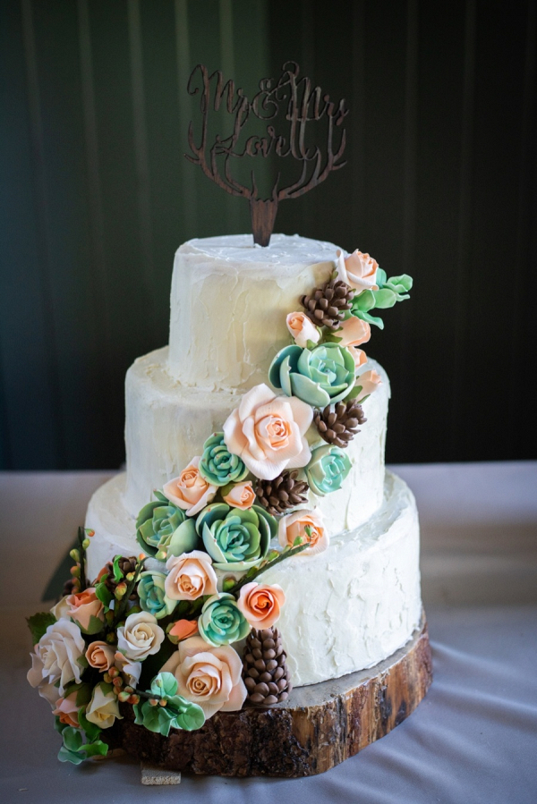 Rustic wedding cake with antler cake topper