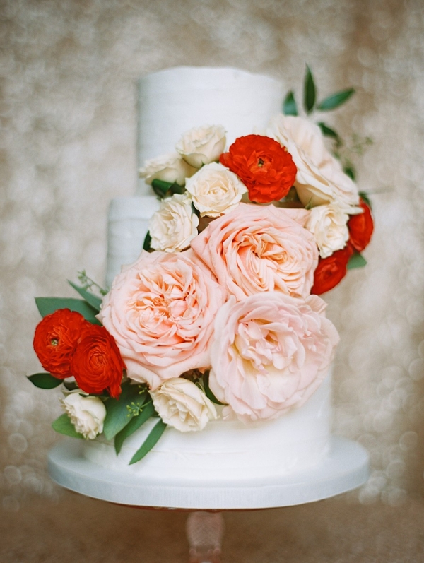 White Wedding Cake with Pink Cabbage Roses and Red Ranunculous