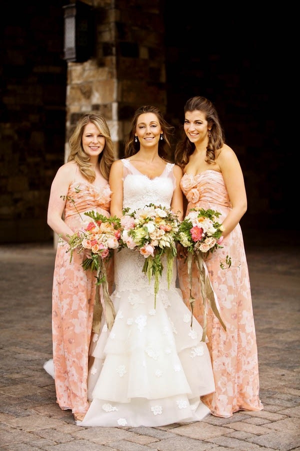 Floor length peach bridesmaid dresses with floral patterns by Amsale