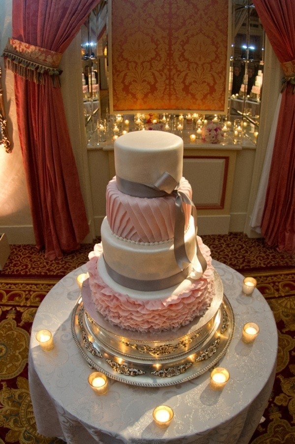 White and pink 4-tier round wedding cake with ruffles, texture and silver ribbon bows