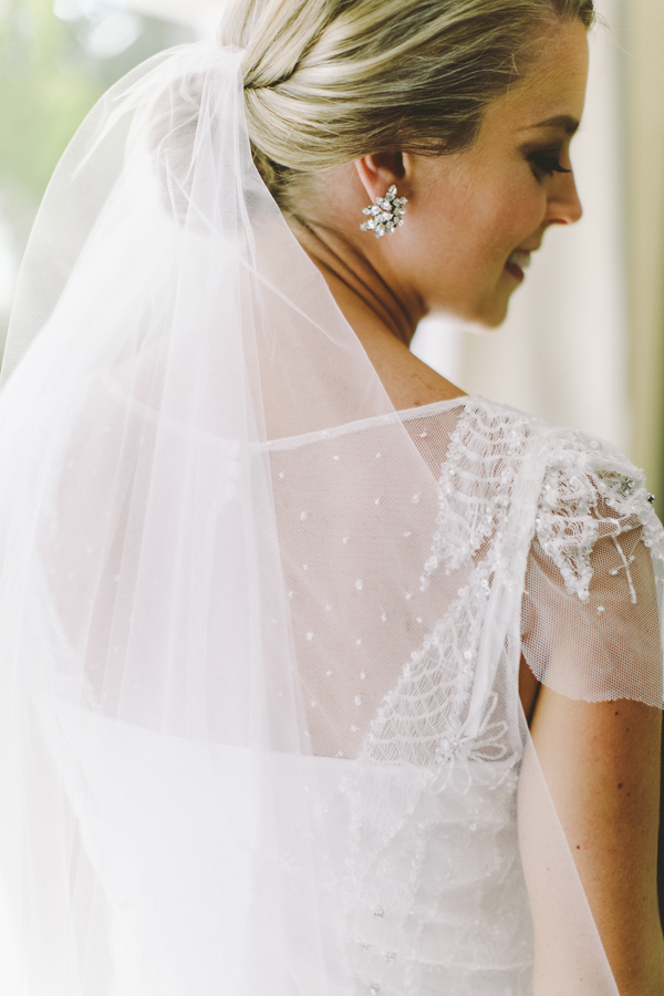 Classic destination wedding bridal look with a simple veil, BHLDN earrings and a Rosa Clara gown