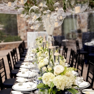 Modern wedding tablescape with hanging candles and a dramatic tablescape