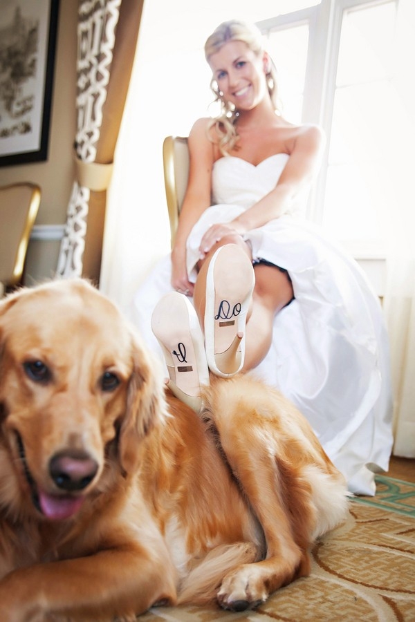 Bride posing with her dog with "I Do" shoe decals