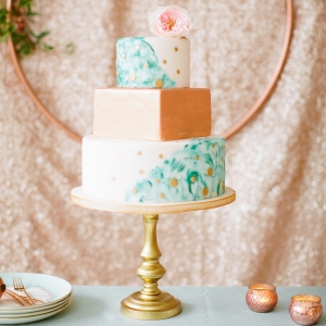 We adore this modern wedding cake with turquoise painted layers and metallic rose gold details