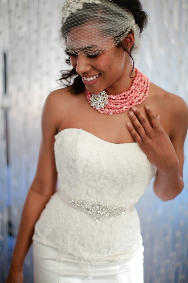 Modern bride with birdcage veil and coral multi-strand necklace