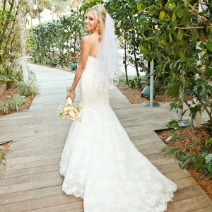 Beach bride in fit and flare wedding dress with sweetheart neckline