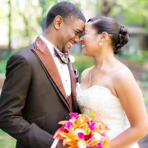 Adorable bride and groom posing nose-to-nose